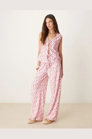 ASOS Pantalones rosas de pernera ancha con estampado de florecitas y lazada delantera de