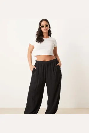 ASOS Pantalones negros a rayas fluidos con bajos ajustados de tejido texturizado de Curve