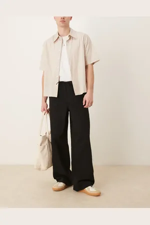 ASOS Pantalones negros muy holgados sin cierres con pinzas y acabado desgastado de
