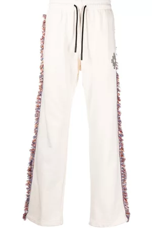 MARCELO BURLON Pantalones de chándal con flecos