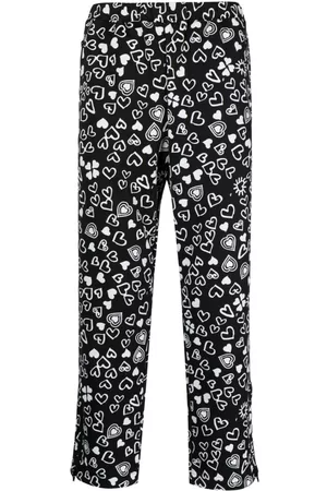 Comme des Garçons Pantalones capri con corazón estampado