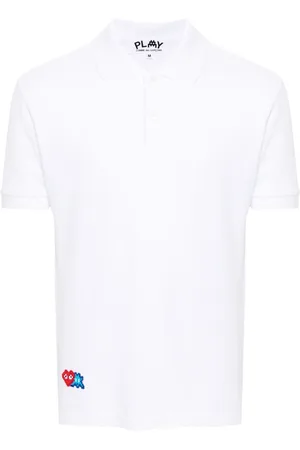Comme des Garçons Polo con apliques pixelados de x The Artist Invader