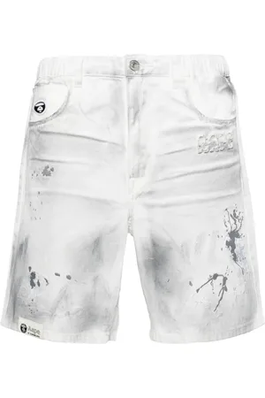 A Bathing Ape Pantalones vaqueros cortos con manchas de pintura