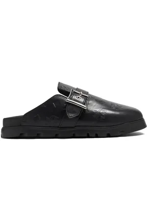 MCM Mules planos con monograma