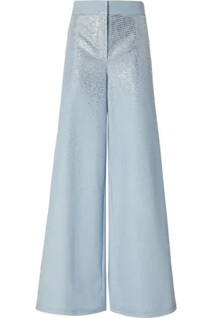 GENNY Vaqueros acampanados con apliques de strass