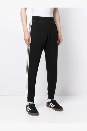 adidas Pantalones de chándal con franjas del logo