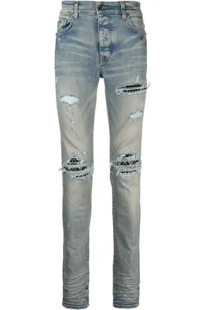 AMIRI Vaqueros pitillo con detalles rasgados MX1