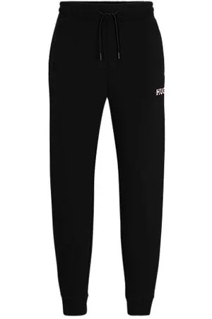 HUGO BOSS Hombre Estampados y Florales - Pantalones de chándal con estampado de monogramas y cinta a rayas